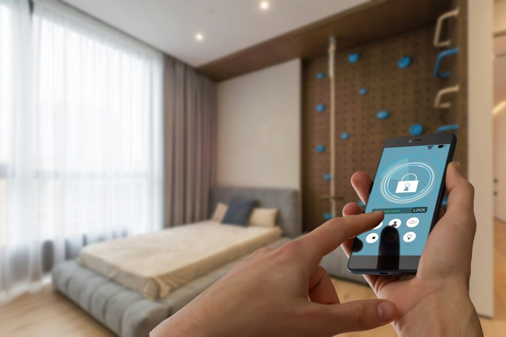 Smart home automation app on smartphone hold by female hand with home interior in background